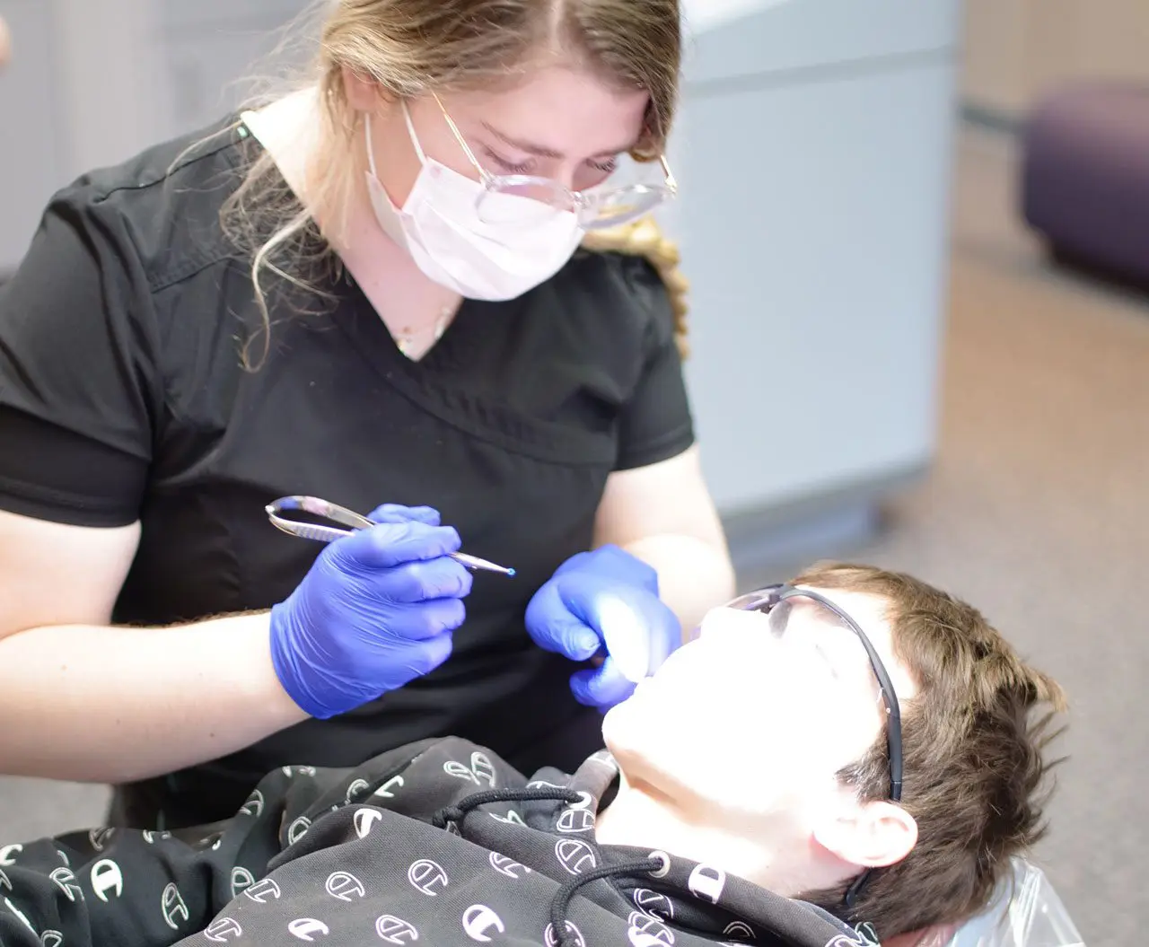 Team member of Daia Orthodontics & TMJ Orthopedics properly examines candidate for braces or clear aligners