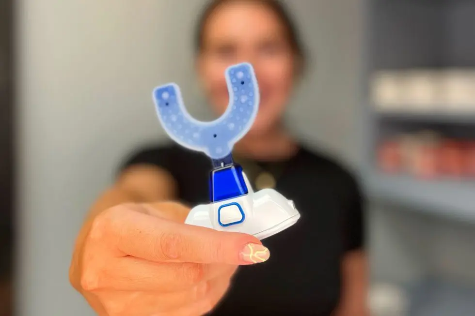 Woman holding the VPro™ system by Propel | Orthodontist using accelerated orthodontic technology