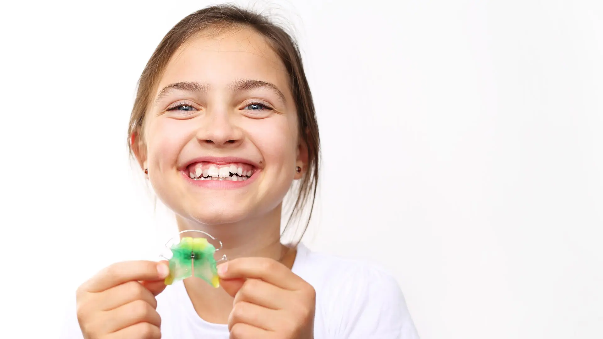 A child with retainers. From Invisalign to braces Rochester has one of the best Orthodontics. Learn more about Daia's Interceptive Orthodontics today.