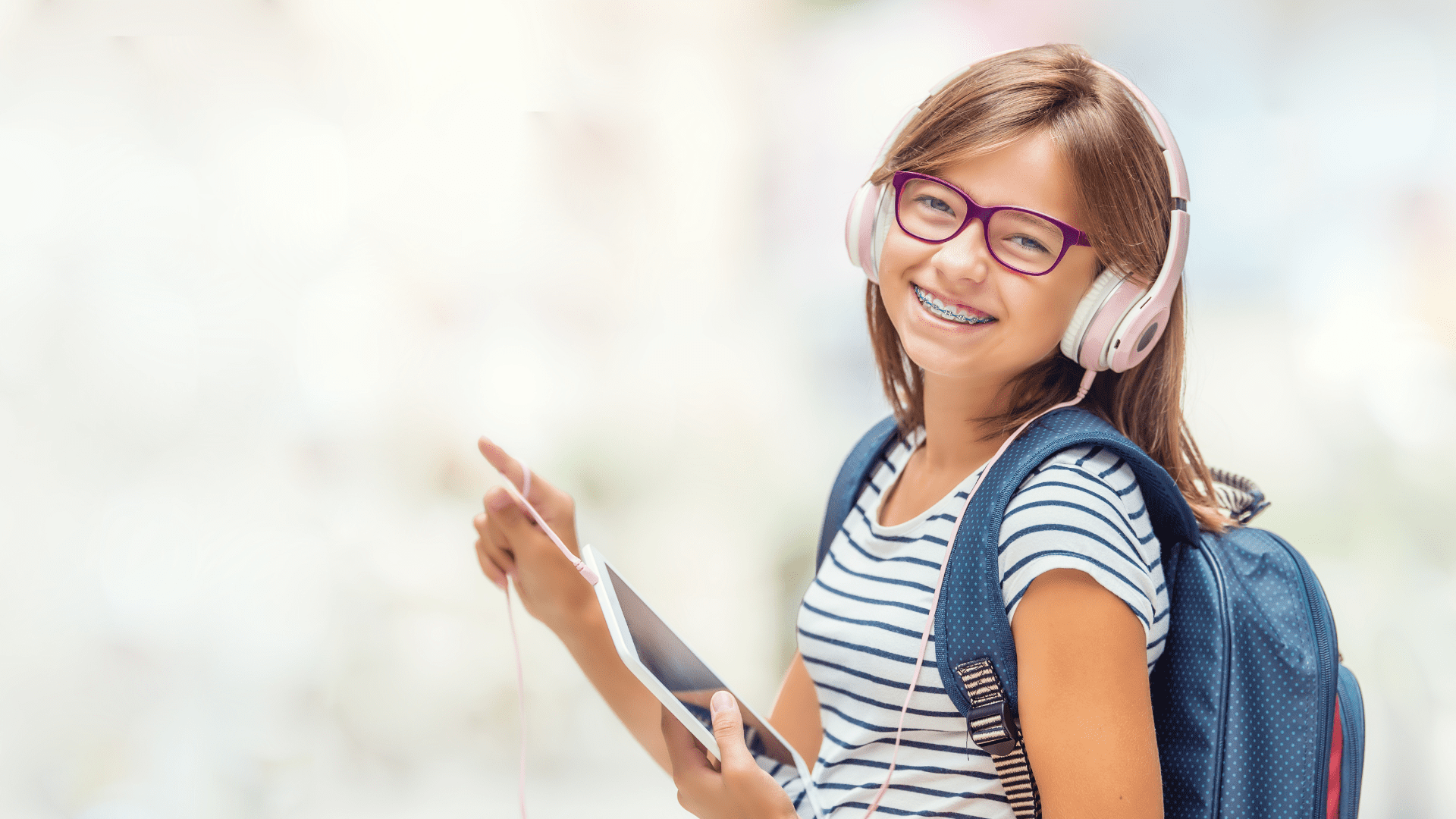 A child with braces thanks to the orthodontist's office that helps straighten teeth in Rochester MI and provide interceptive orthodontic treatment. Get your child orthodontic checkup before school starts!