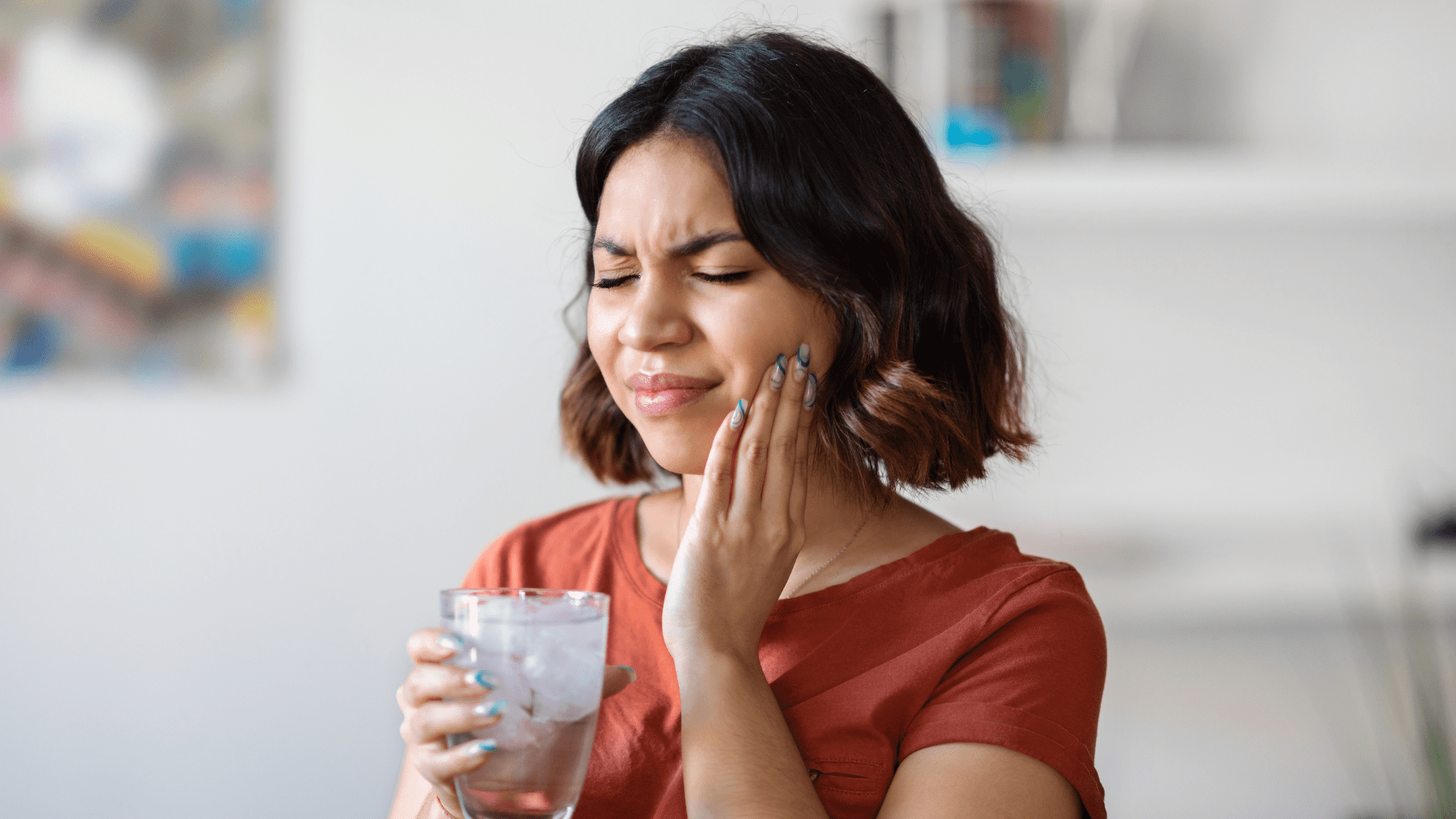 A woman experiencing winter tooth sensitivity due to the Michigan cold weather