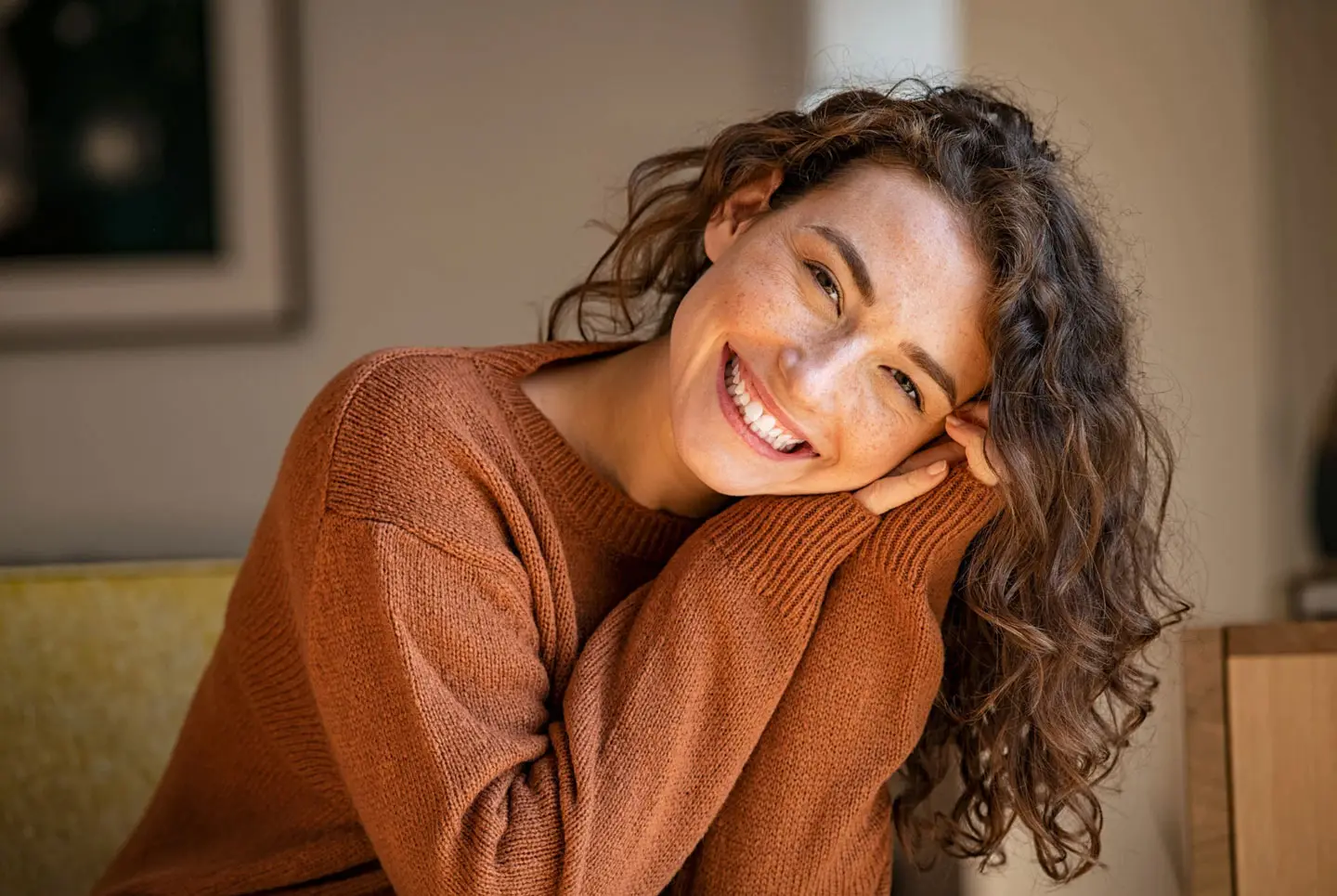 Woman smiling confidently with straight teeth after orthodontic treatment