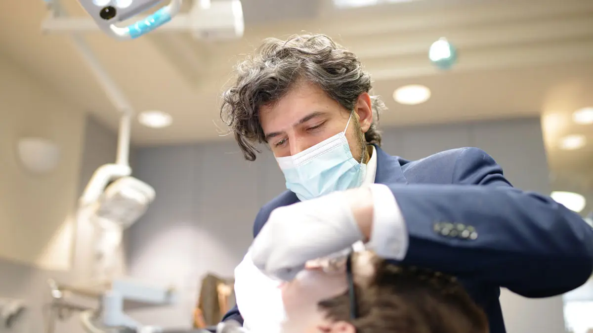 Dr. Daia masked and performing a modern orthodontic procedure