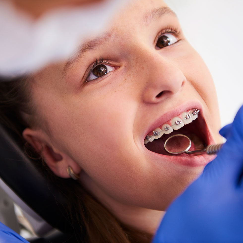 Dental assistant working on a child patient