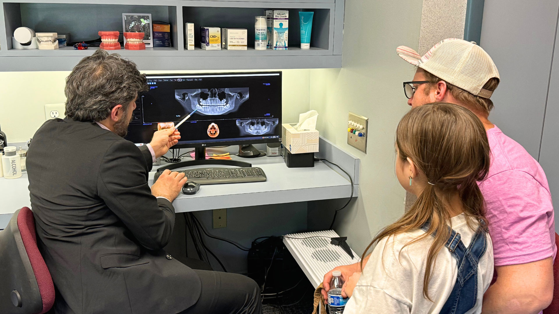 Dr.Daia and a child looking at wisdom teeth on a computer screen.