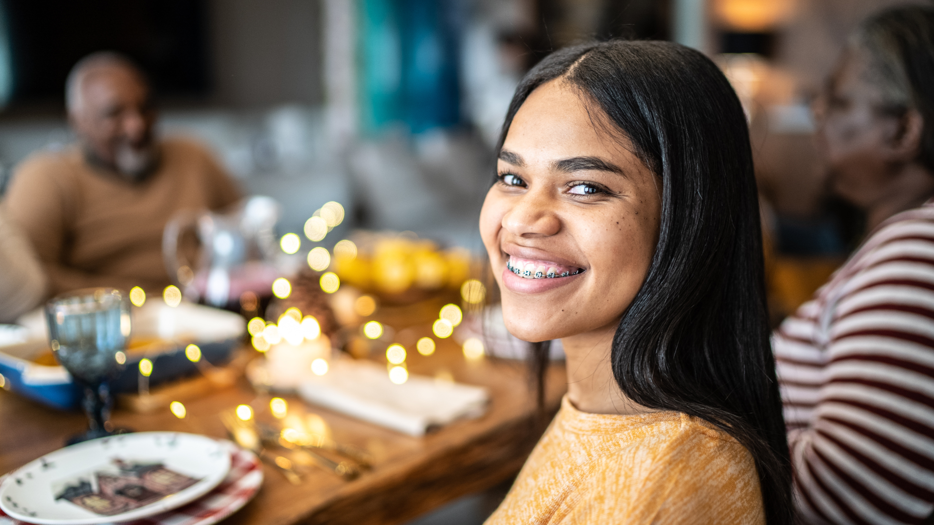 girl smiling with braces, a treatment from one of the best orthodontists in Detroit.