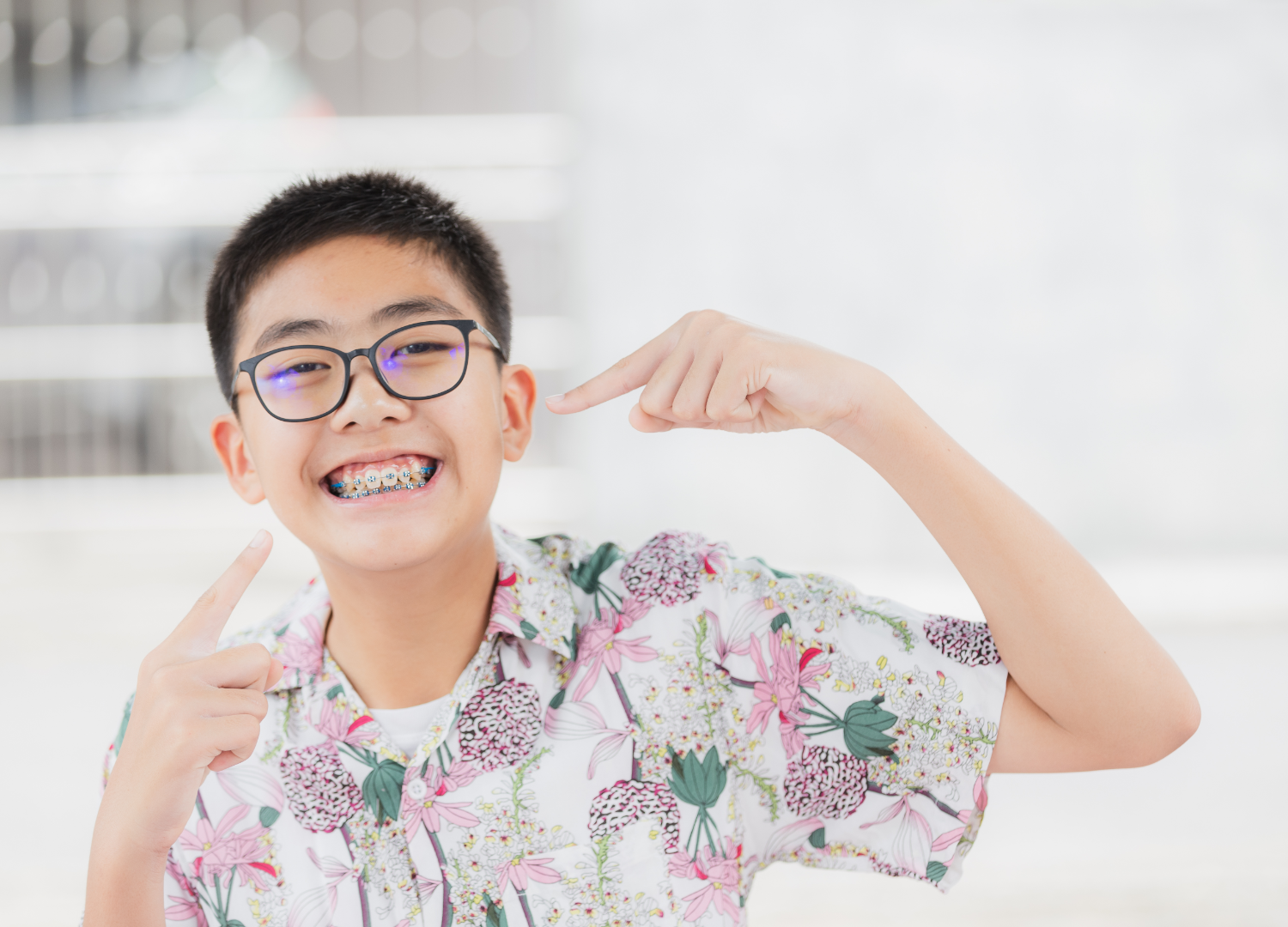 A child pointing at his braces